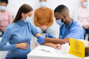 Pregnant woman in mask gets coronavirus vaccine | RSC of the SF Bay Area
