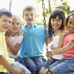 Group Of Children Having Fun In Playground Together