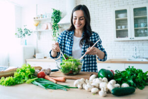 Woman preparing a healthy salad as part of a PCOS diet | Reproductive Science Center of the SF Bay Area