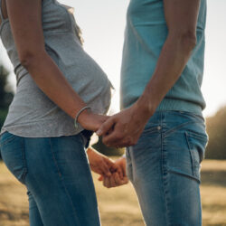 couple holding hands and facing each other after fertility cycle | Reproductive Science Center of the SF Bay Area